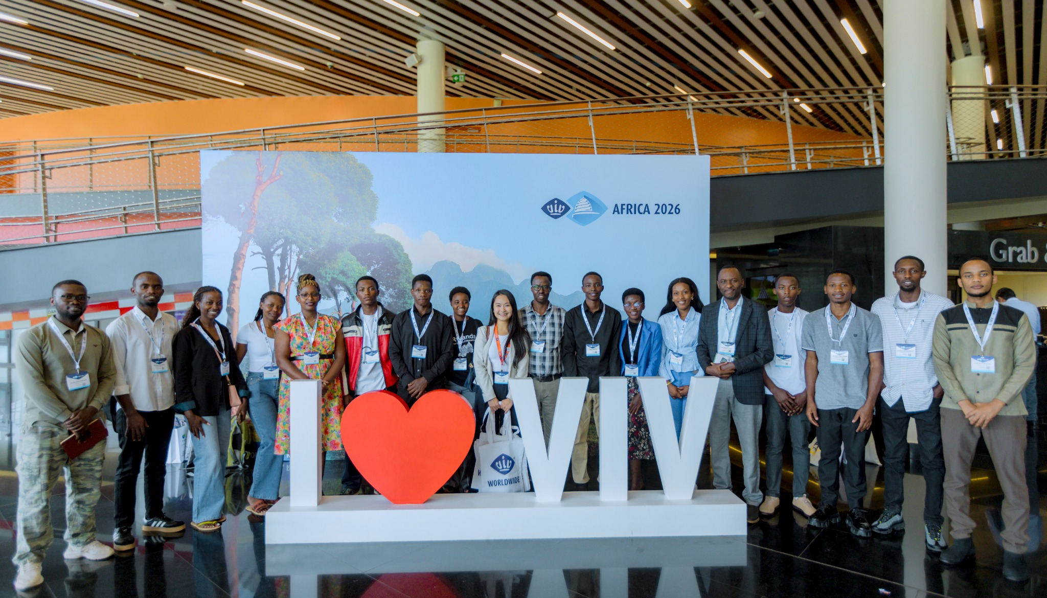 Group of VIV Africa 2026 participants posing together behind the I Love VIV sign at the Kigali Convention Centre in Rwanda.